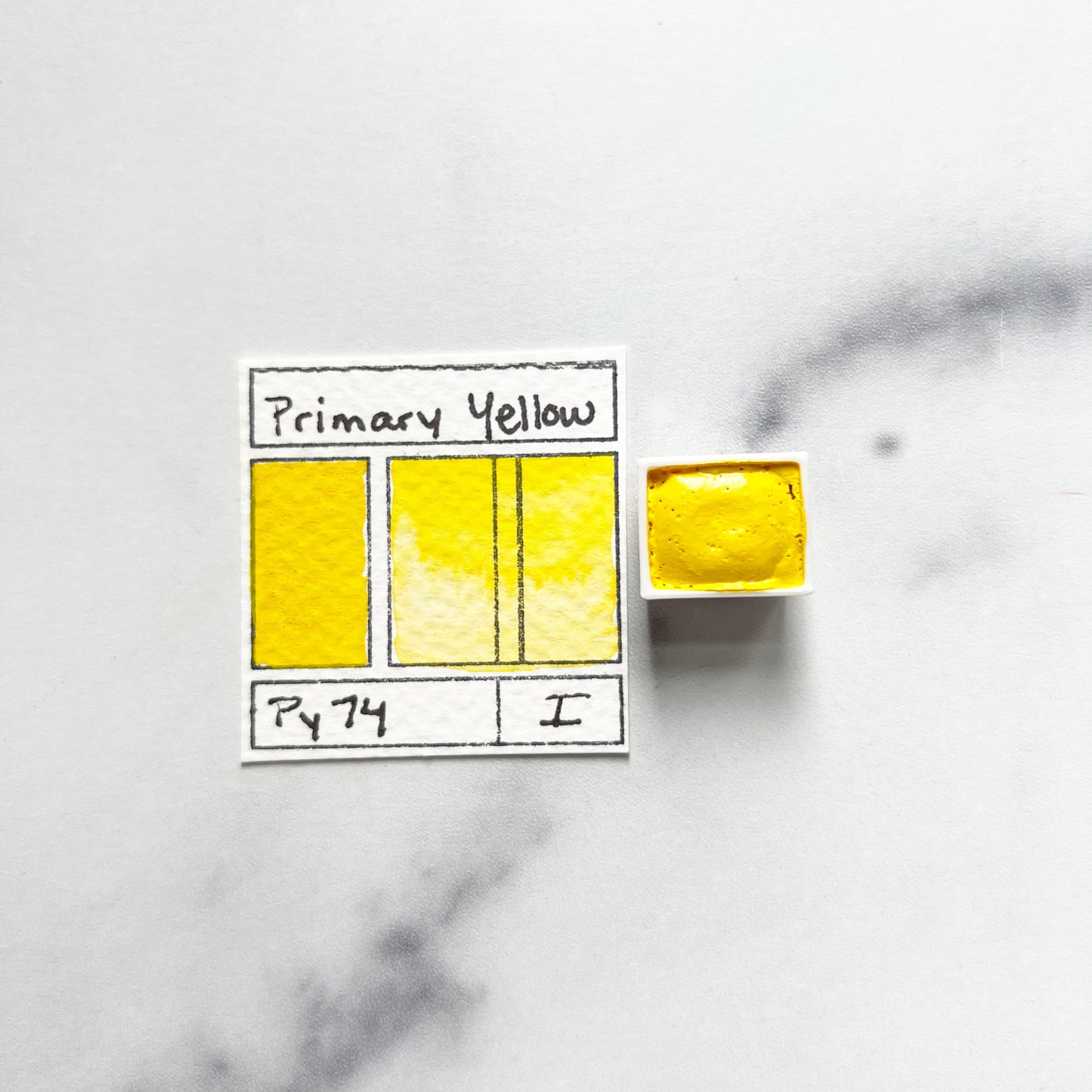 Primary Yellow. Half pan or bottle cap of handmade watercolor paint