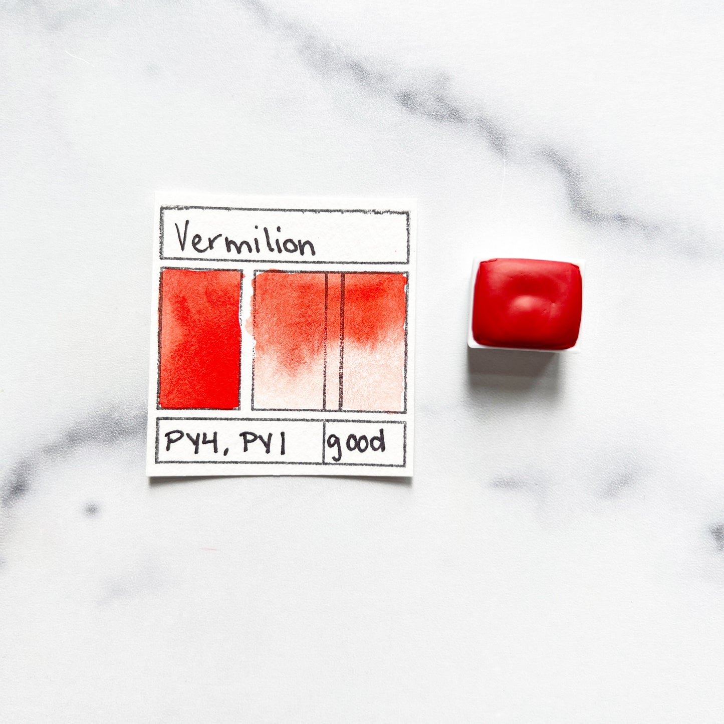 Vermilion. Half pan or bottle cap of handmade watercolor paint