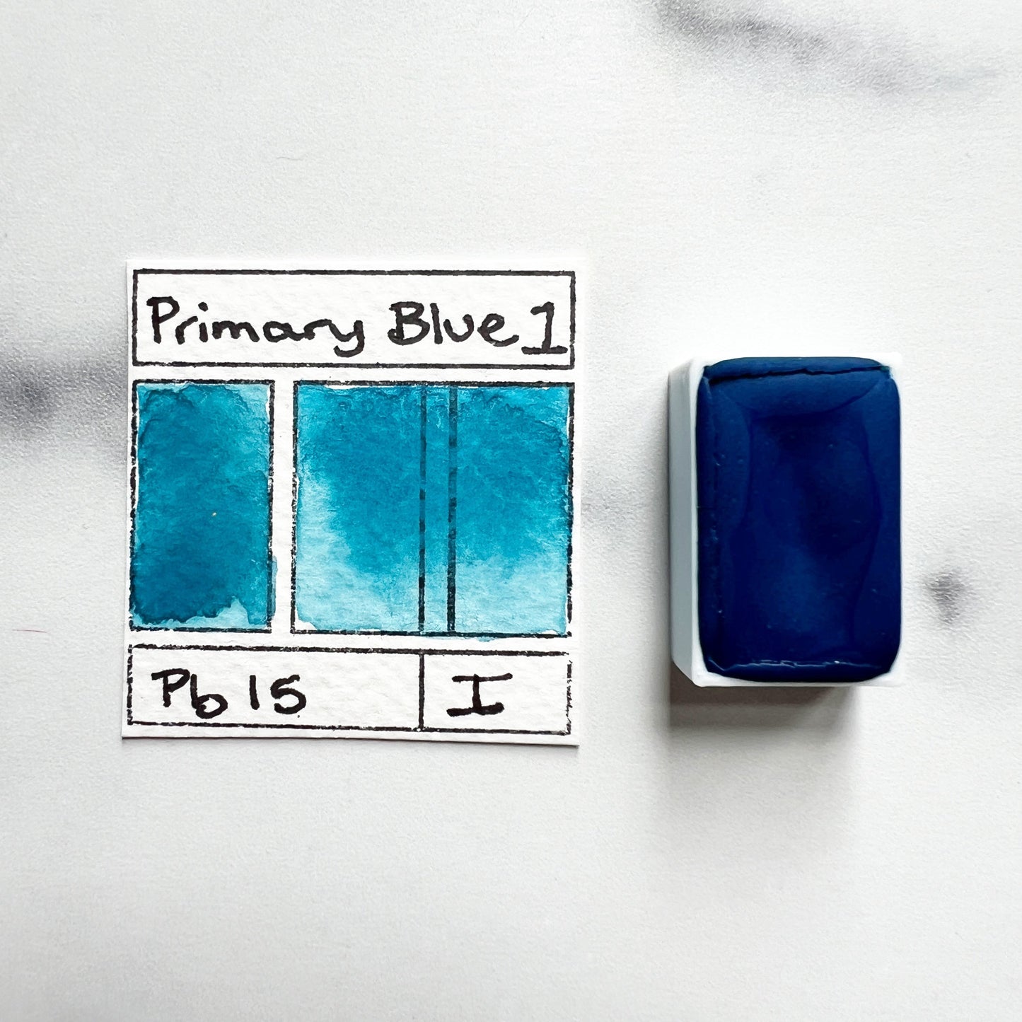 Primary Blue. Half pan or bottle cap of handmade watercolor paint