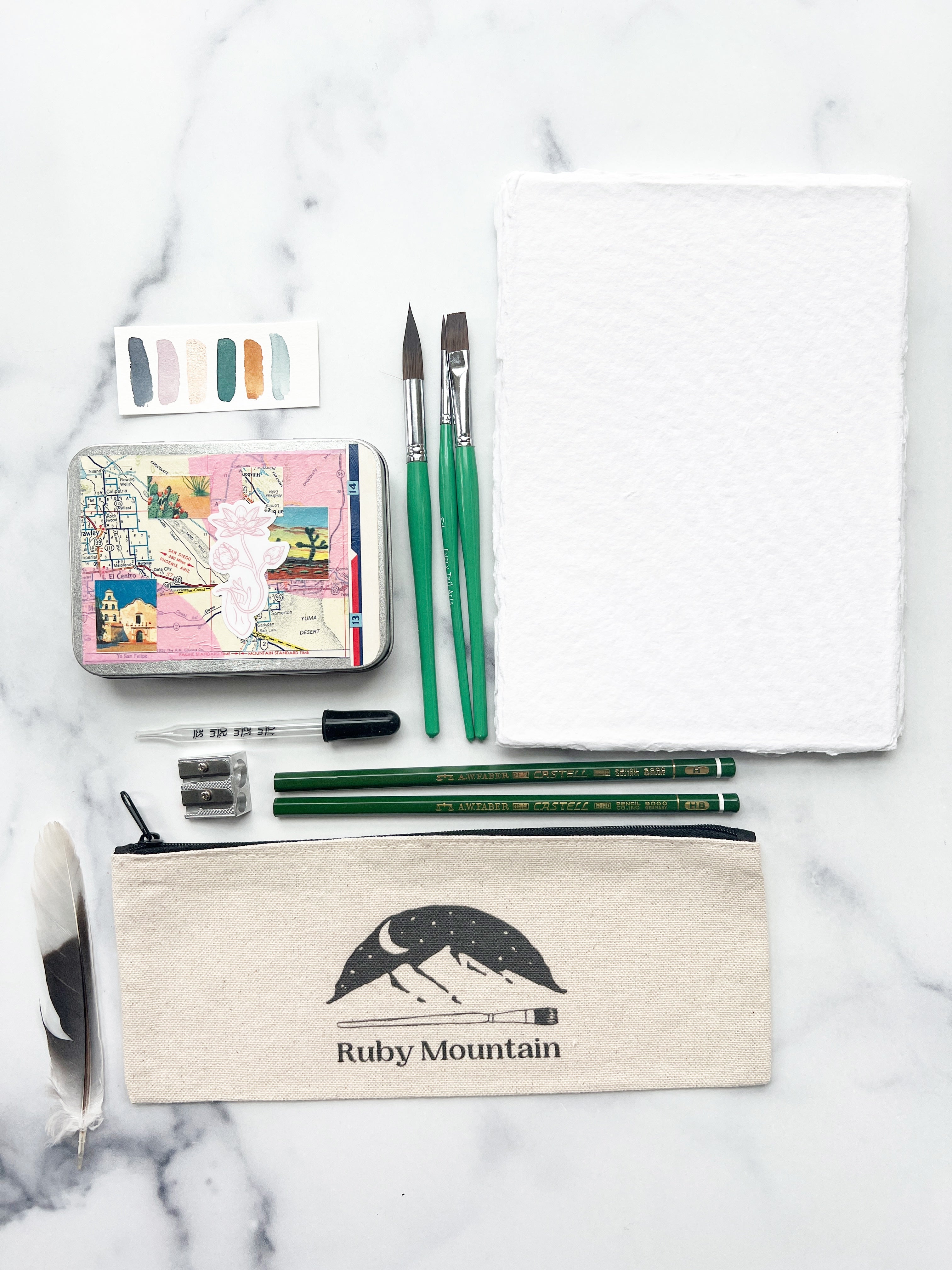 The Yuma Set, a handmade watercolor set in a collaged tin