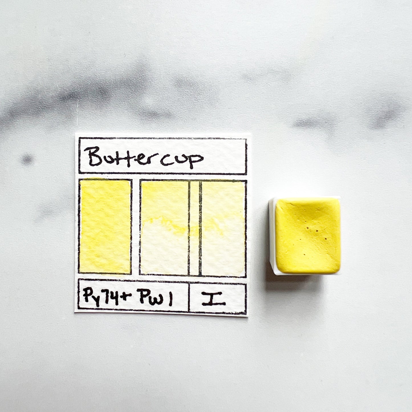 Buttercup. Half pan or bottle cap of handmade watercolor paint