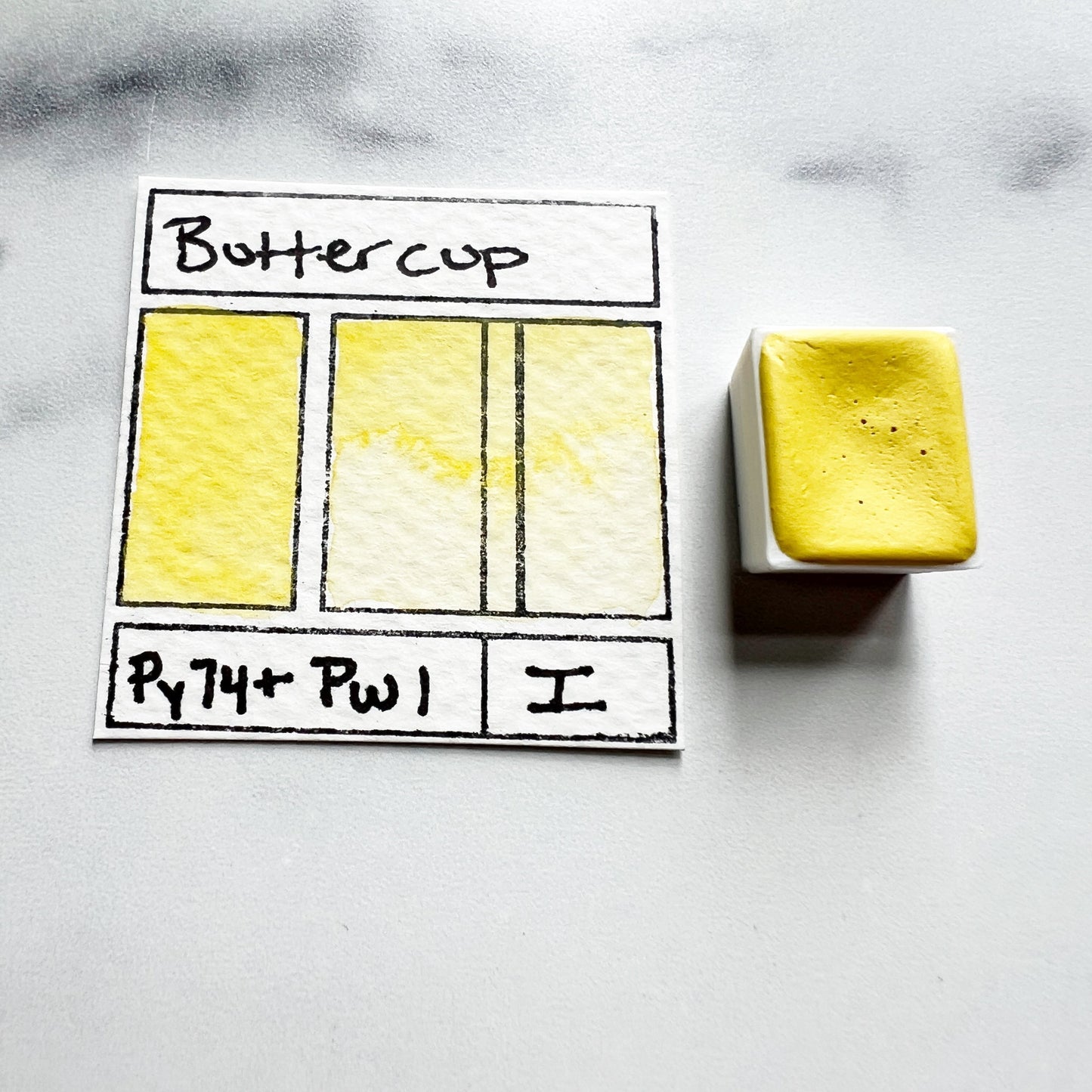 Buttercup. Half pan or bottle cap of handmade watercolor paint