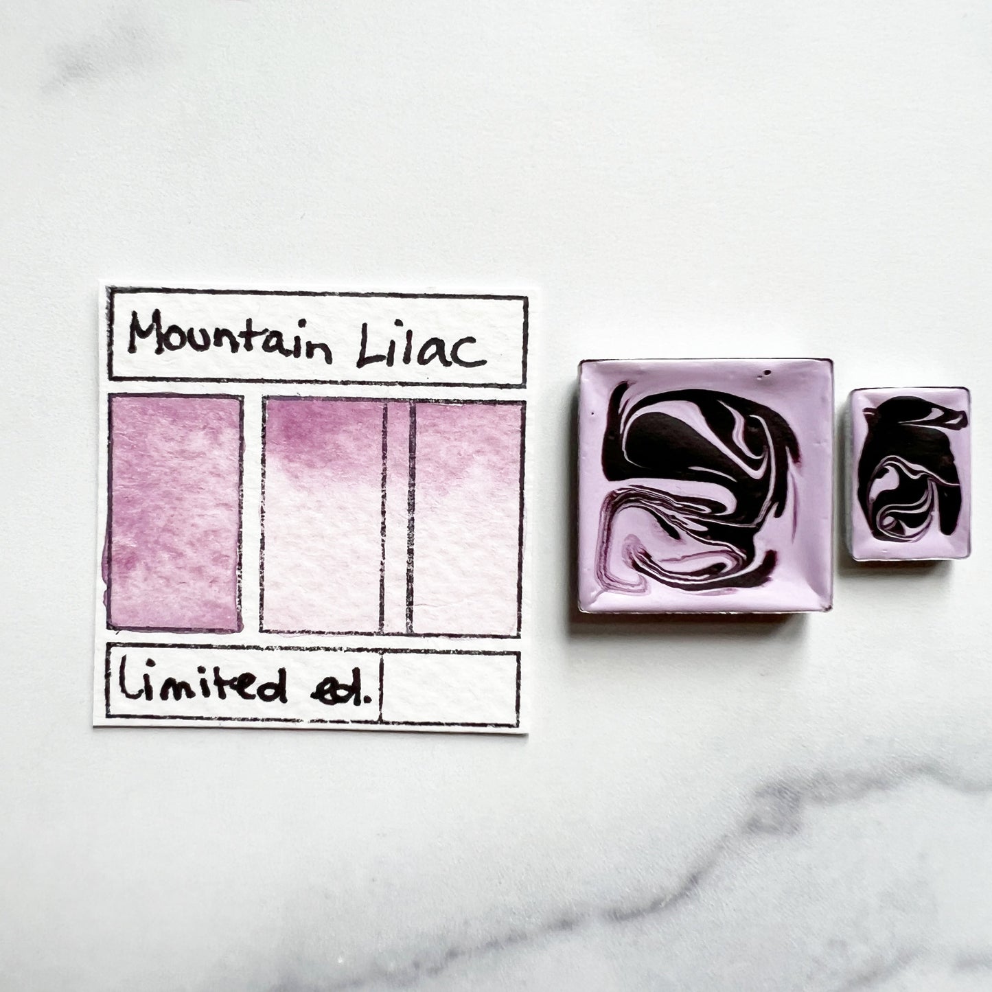 RM Mountain Lilac. Half pan or bottle cap of handmade watercolor paint