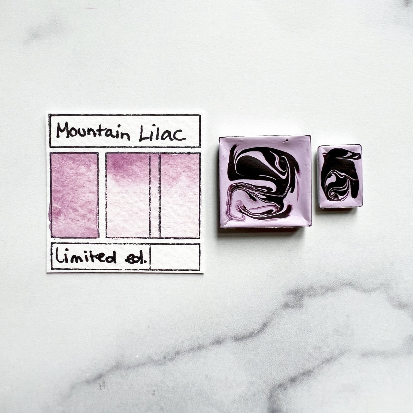 RM Mountain Lilac. Half pan or bottle cap of handmade watercolor paint