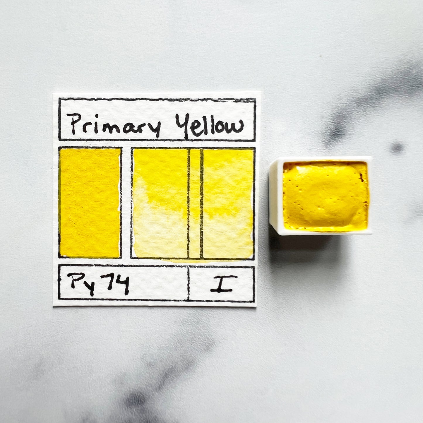 Primary Yellow. Half pan or bottle cap of handmade watercolor paint