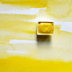 Primary Yellow. Half pan or bottle cap of handmade watercolor paint