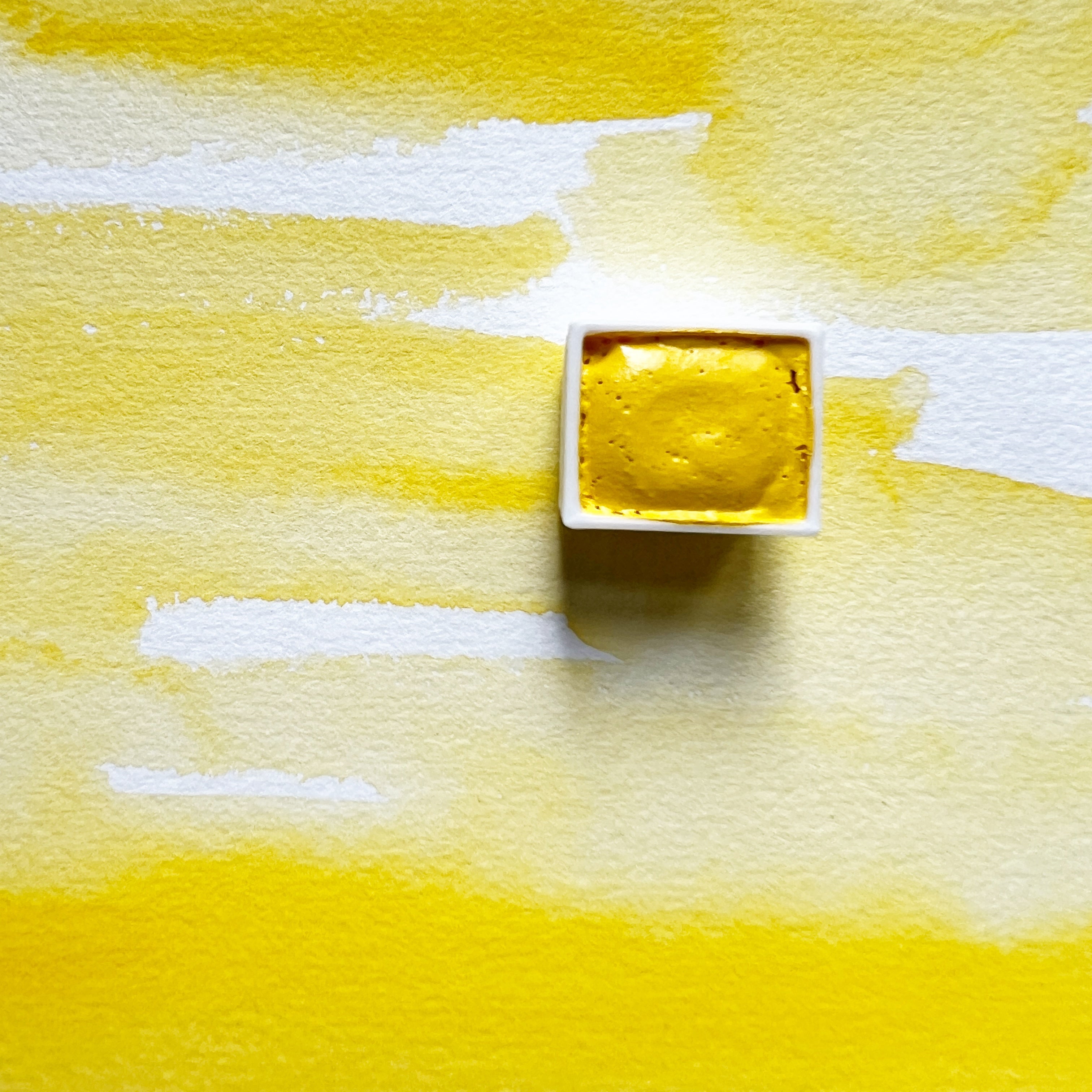 Primary Yellow. Half pan or bottle cap of handmade watercolor paint