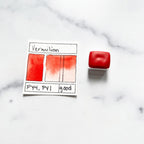 Vermilion. Half pan or bottle cap of handmade watercolor paint