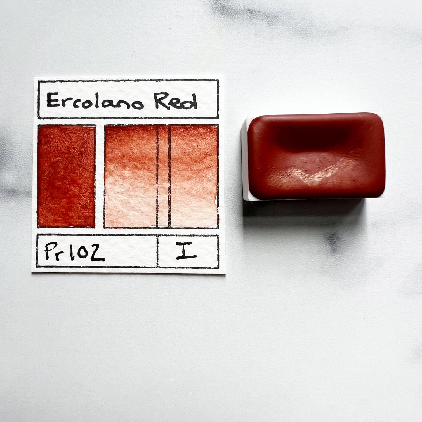 Ercolano Red. Half pan or bottle cap of handmade watercolor paint