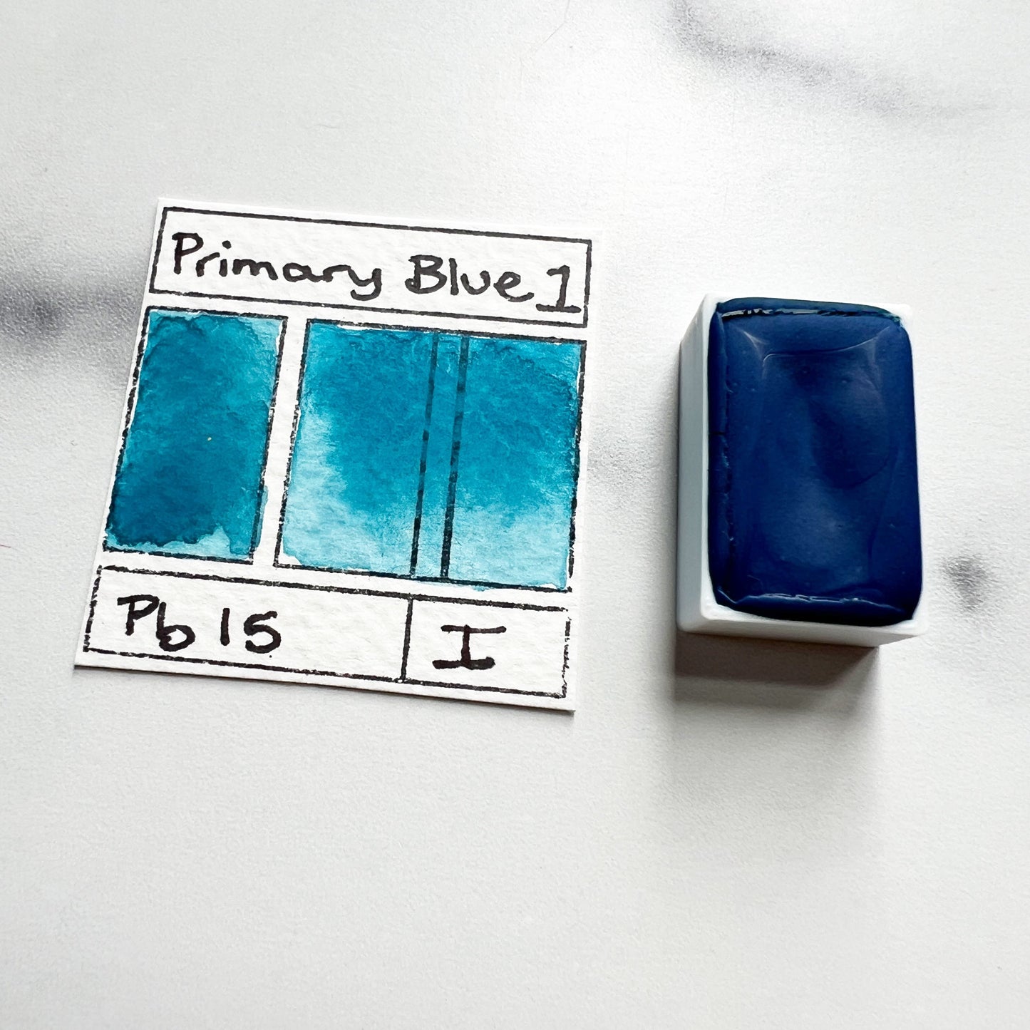 Primary Blue. Half pan or bottle cap of handmade watercolor paint