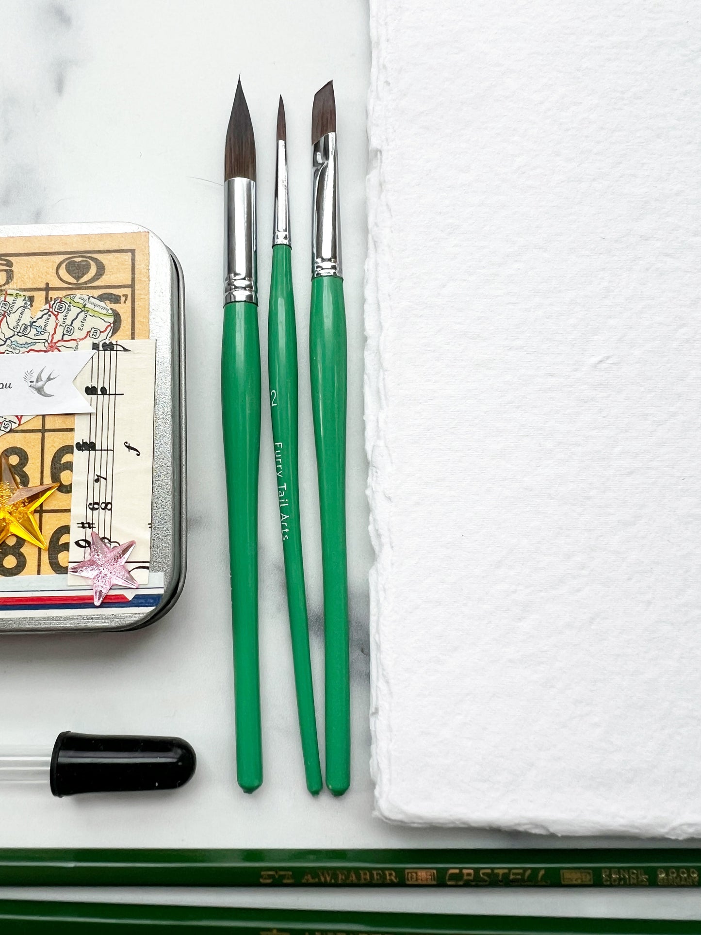 The Hilda Set, a handmade watercolor set in a collaged tin