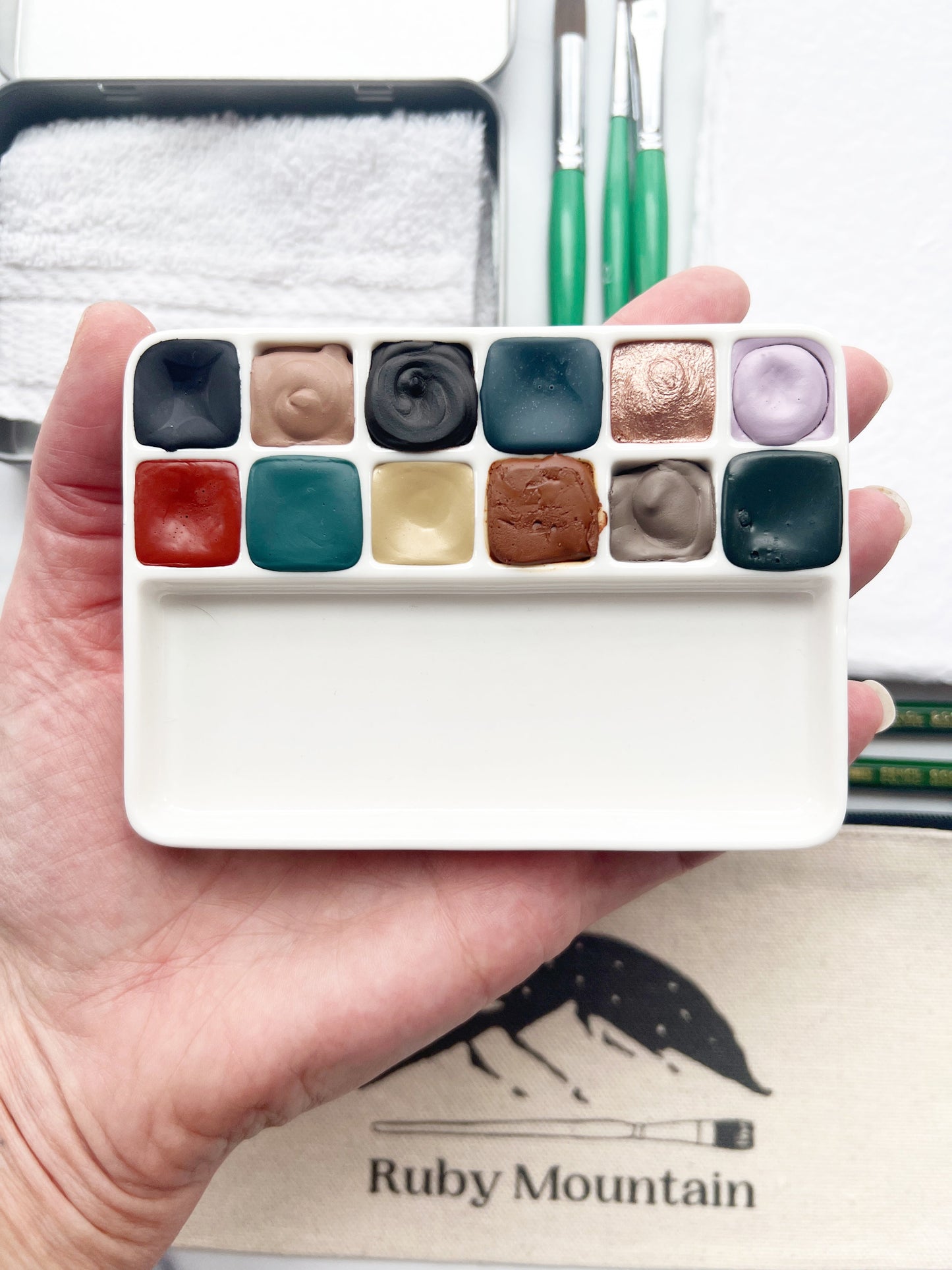 The Hilda Set, a handmade watercolor set in a collaged tin