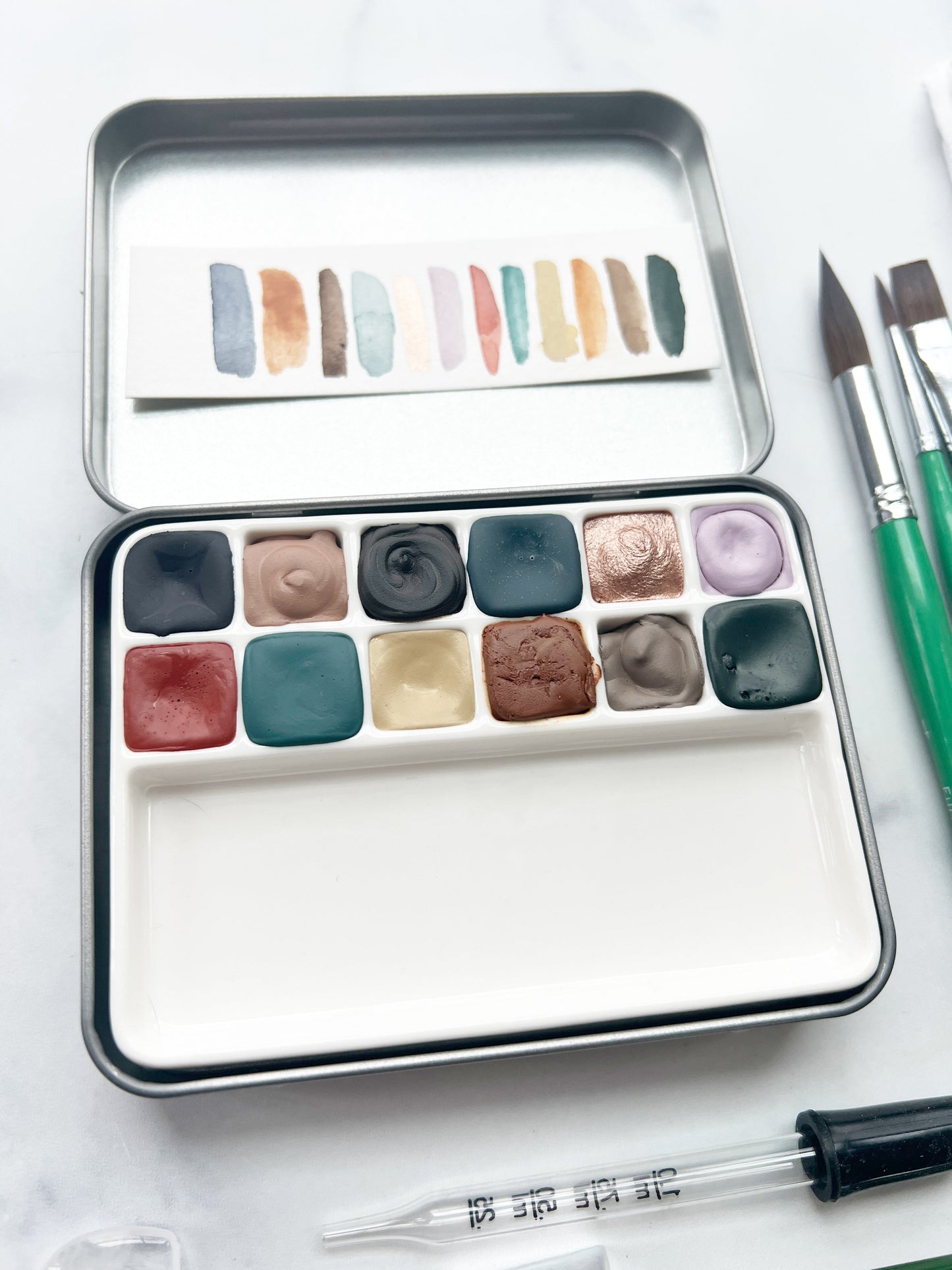 The Hilda Set, a handmade watercolor set in a collaged tin