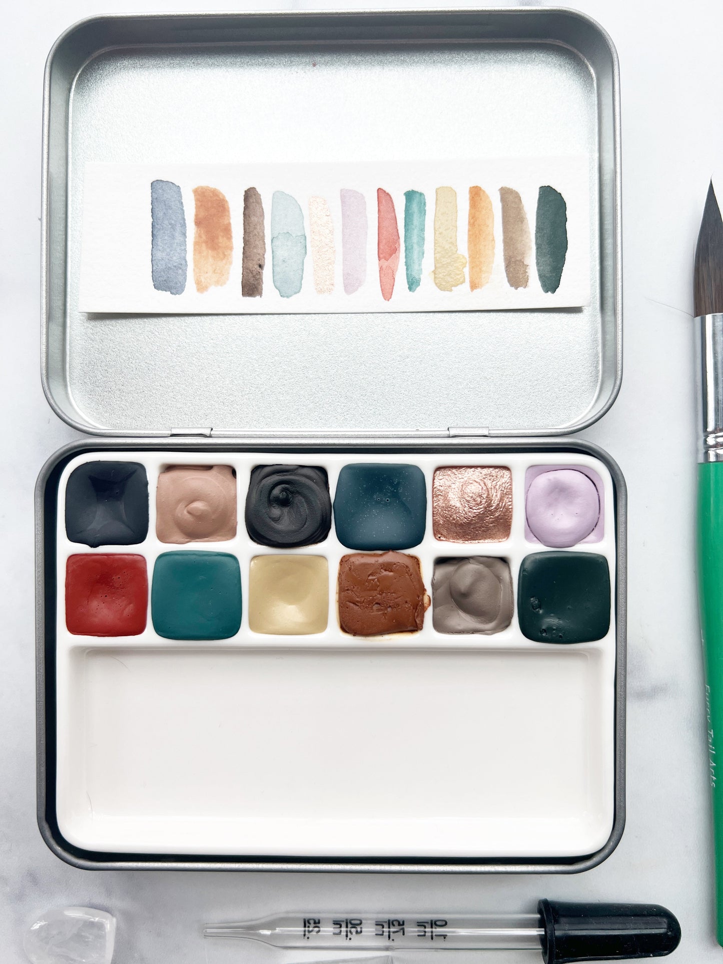 The Hilda Set, a handmade watercolor set in a collaged tin