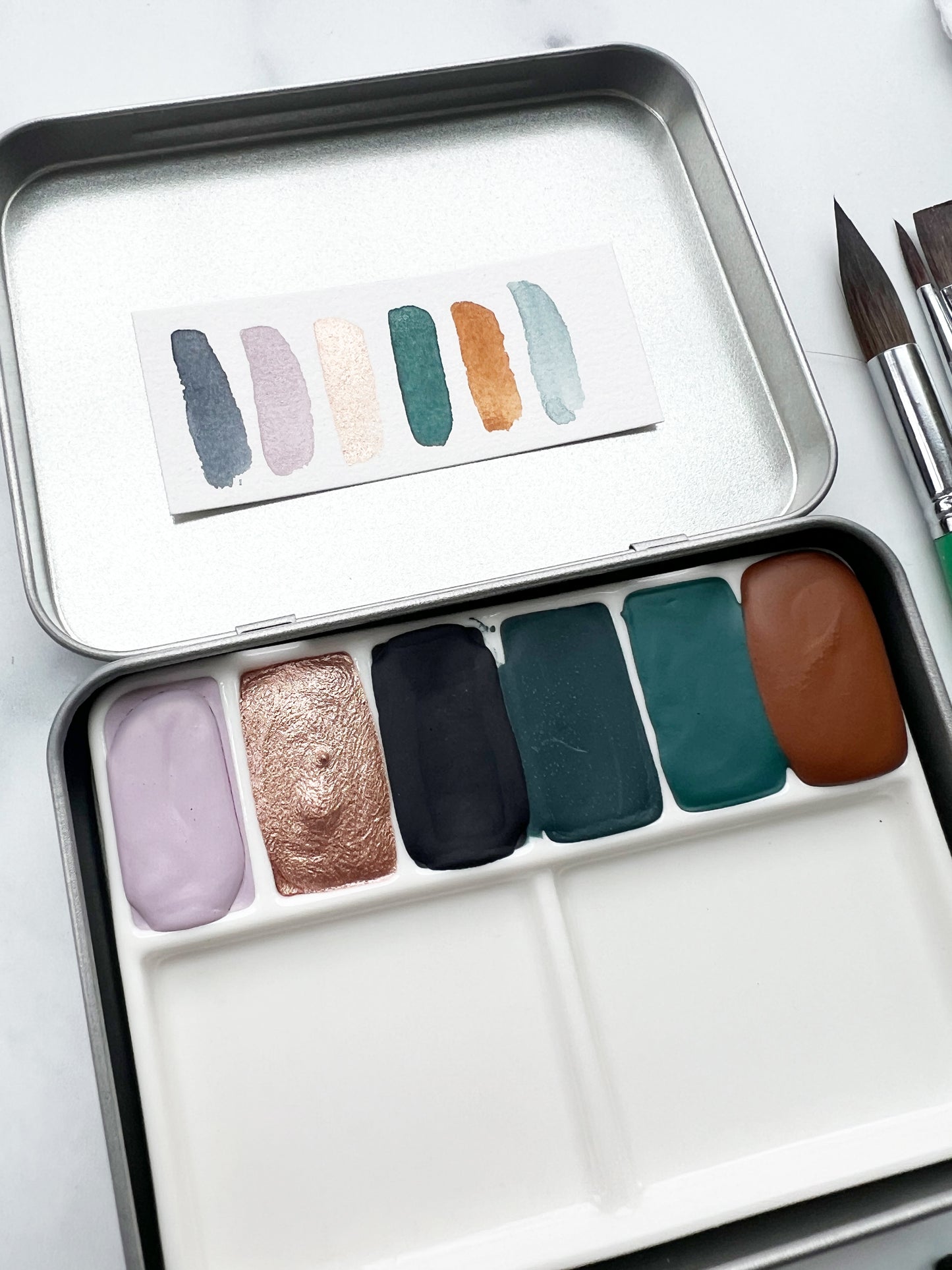 The Yuma Set, a handmade watercolor set in a collaged tin