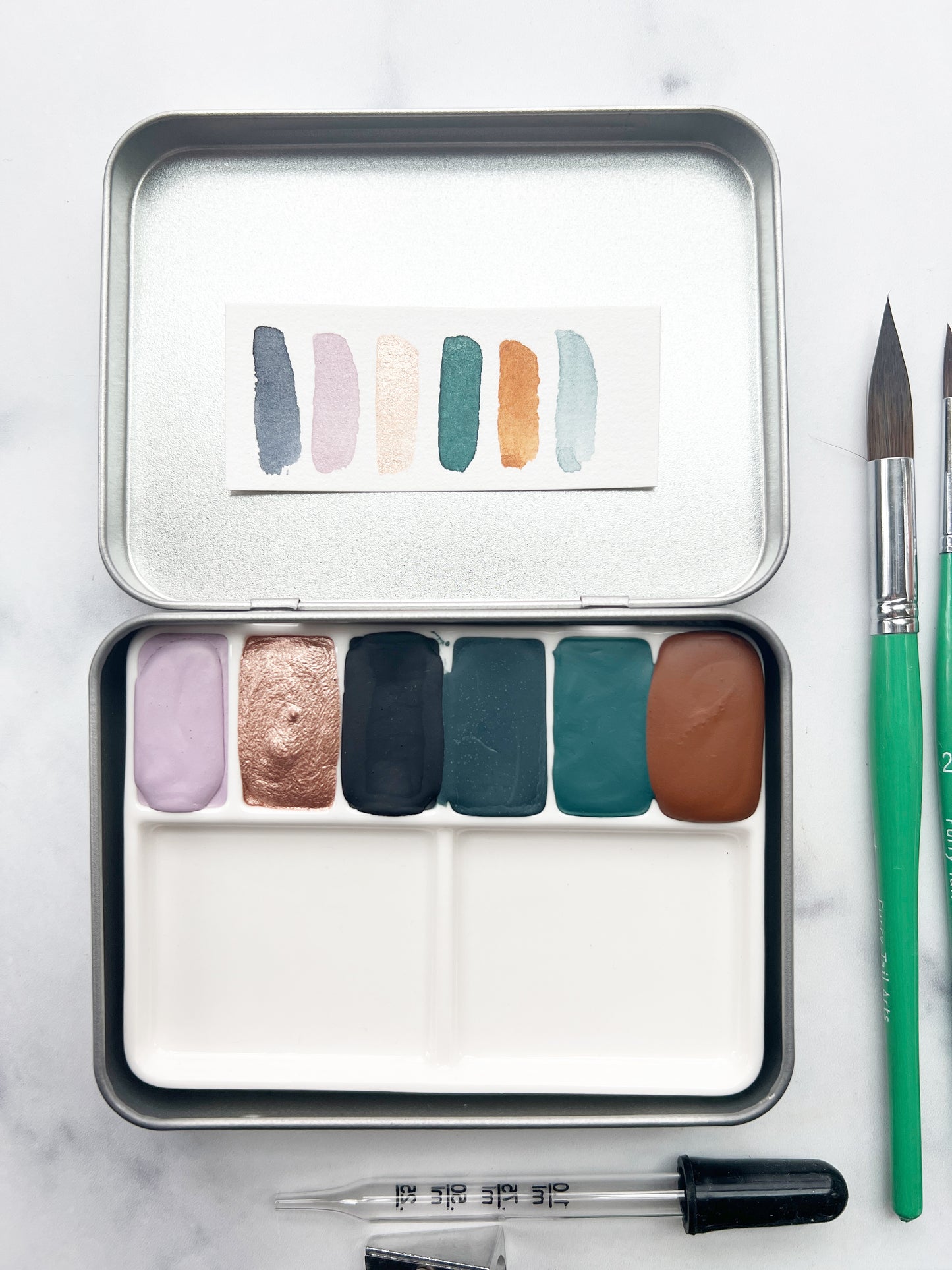 The Yuma Set, a handmade watercolor set in a collaged tin