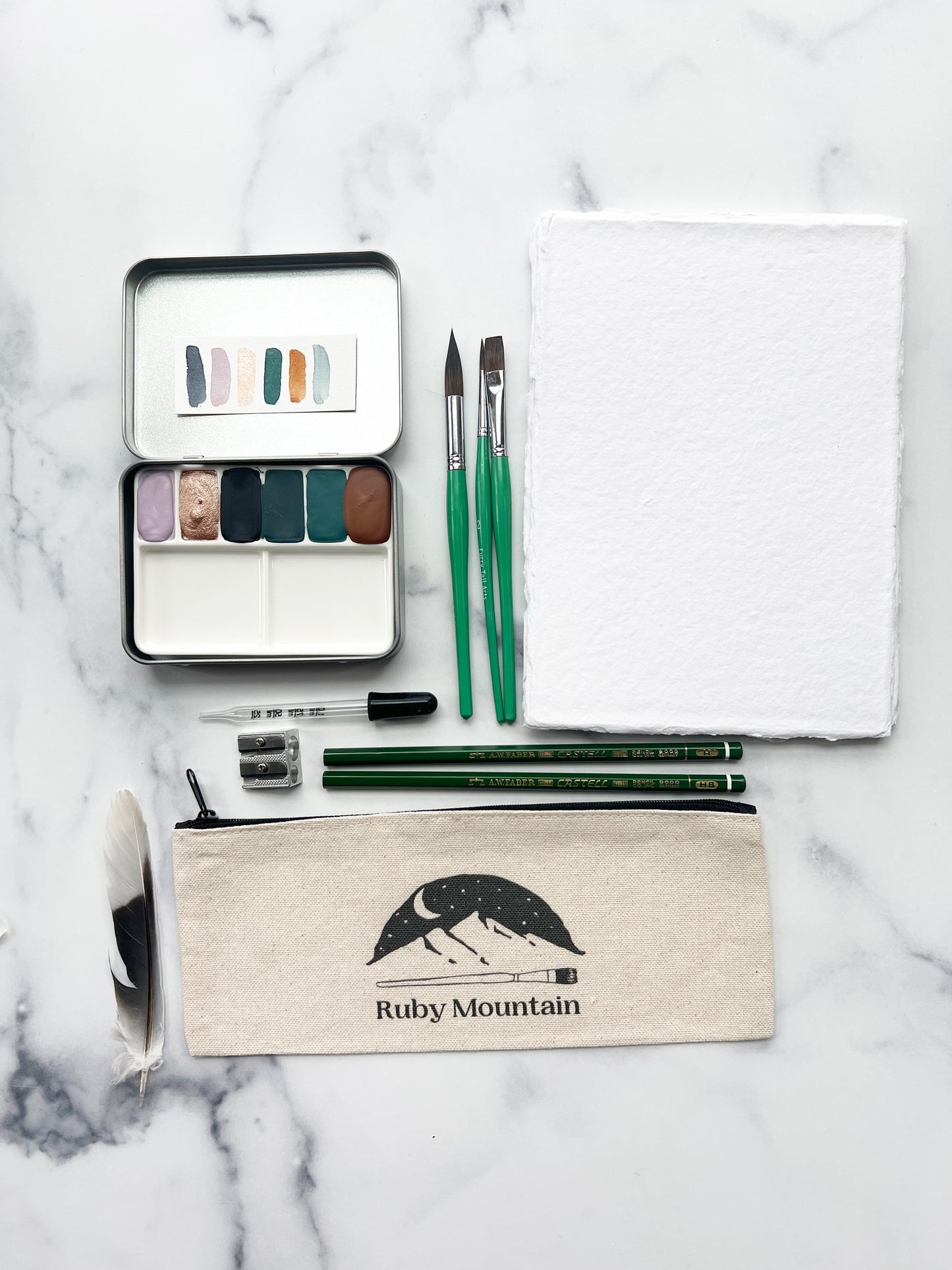 The Yuma Set, a handmade watercolor set in a collaged tin